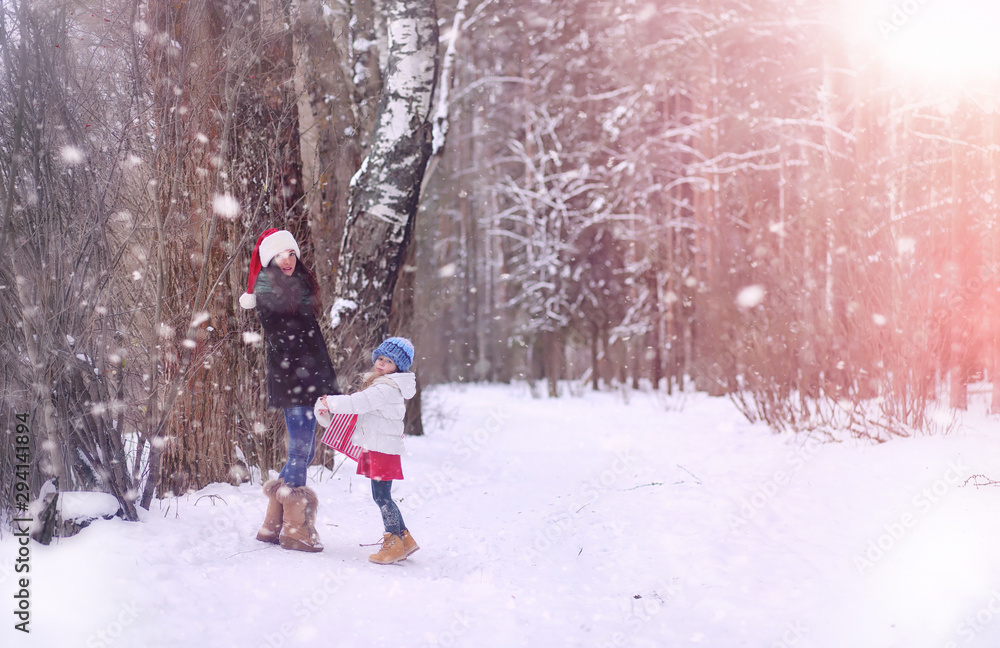 A winter fairy tale,in the forest. A girl on a sled with gifts on the eve of the new year in the park. Two sisters walk in a New Year's park and ride a sled with gifts. A winter fairy tale,in the forest. A girl on a sled with gifts on the eve of the new year in the park. Two sisters walk in a New Year's park and ride a sled with gifts.