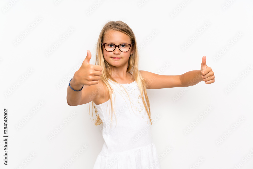 Little girl over isolated white wall making victory gesture Little girl over isolated white wall making victory gesture