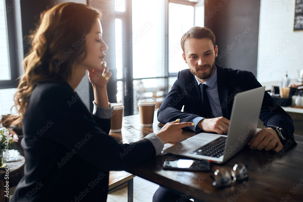 serious woman pointing at the screan, correcting her colleague's mistakes at workplace, close up photo serious woman pointing at the screan, correcting her colleague's mistakes at workplace, close up photo