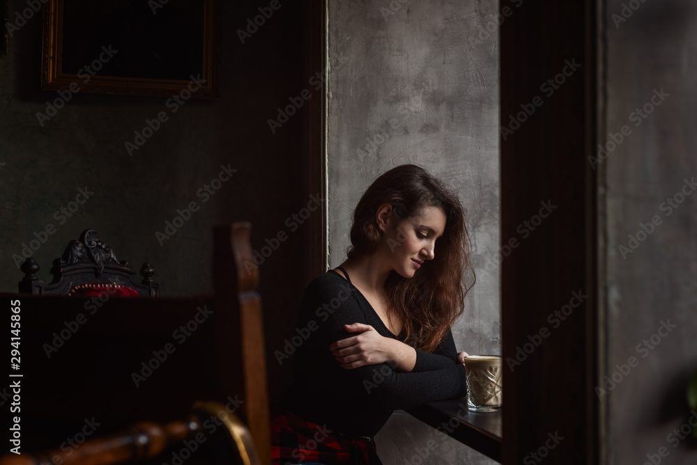 Beautiful woman with lohg brunette hair in a cafe Beautiful woman with lohg brunette hair in a cafe