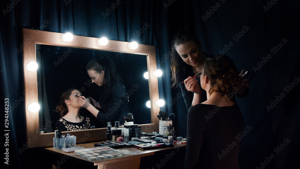 Beautician applying makeup