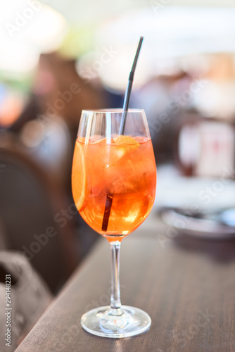 Cocktail with orange and ice in glass with