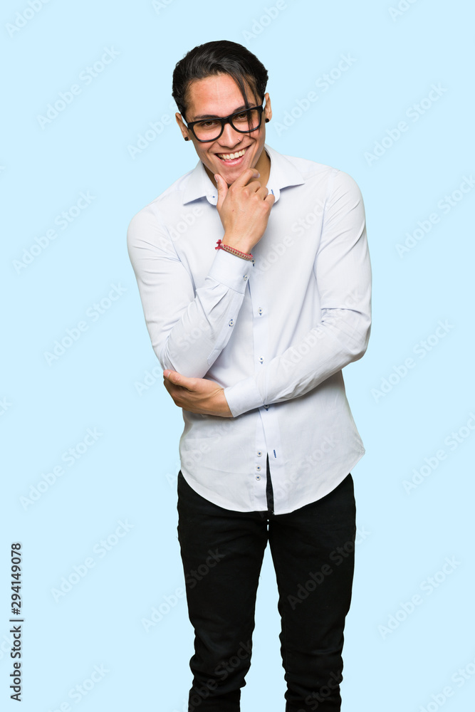 Handsome man with glasses and smiling over isolated blue background Handsome man with glasses and smiling over isolated blue background