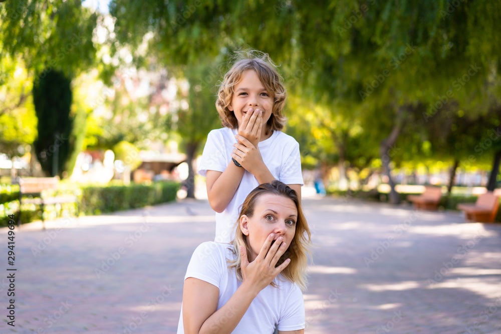 Mother and son in a park doing surprise gesture Mother and son in a park doing surprise gesture