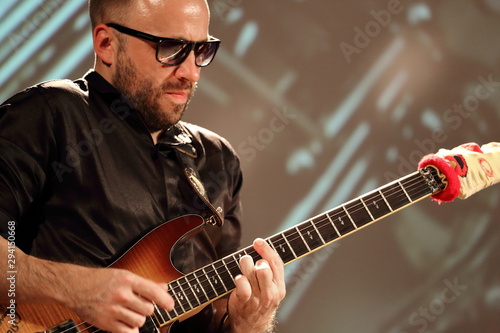 young man playing electric guitar