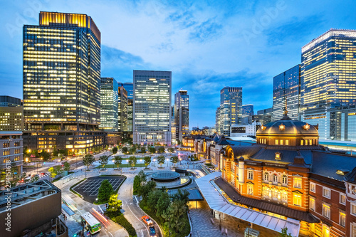 Tokyo city skyline at railway station surround by modern highrise building at twilight time.  Tokyo city, Japan.
