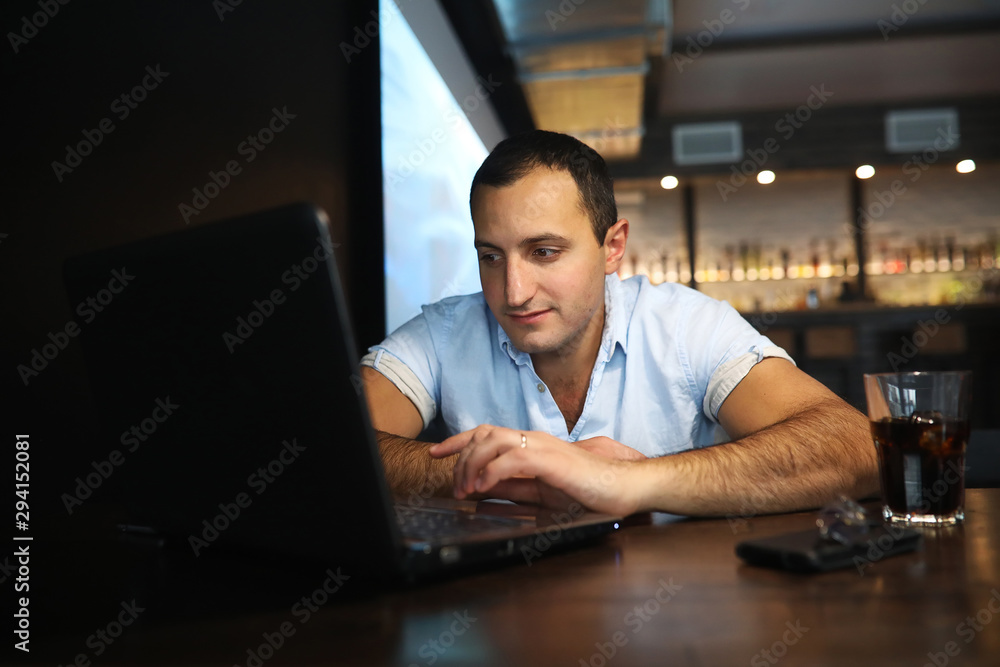 Armenian handsome man working behind laptop Armenian handsome man working behind laptop