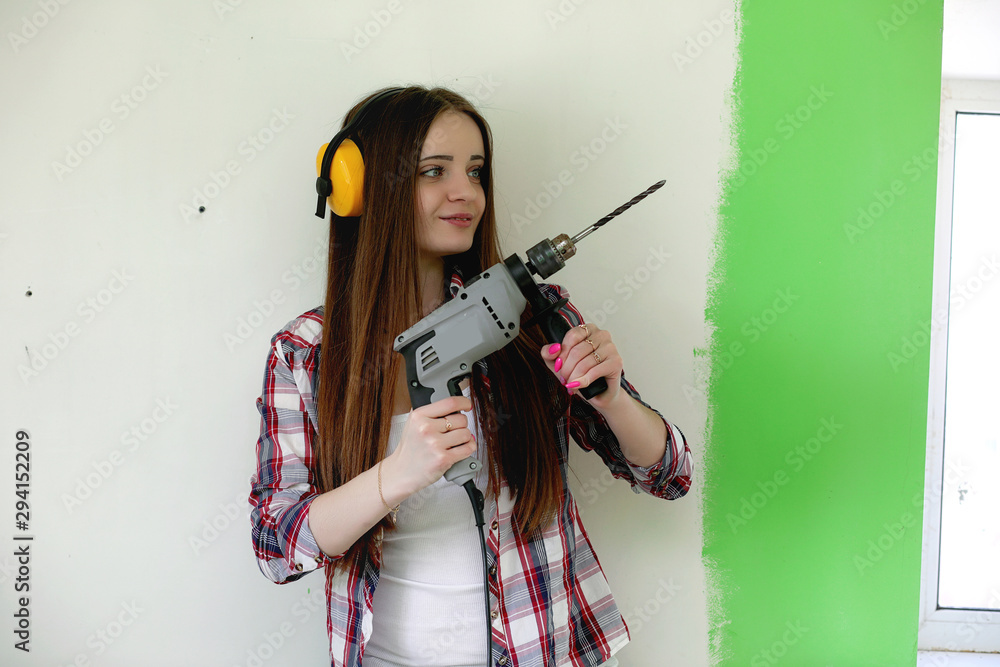 The builder makes repairs in the apartment. Finishing works on plastering and painting of walls. Masters work with paint drill and electricity. The builder makes repairs in the apartment. Finishing works on plastering and painting of walls. Masters work with paint drill and electricity.