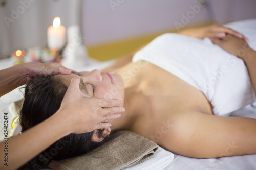An Asian woman is massaging a herbal spa with a relaxing, happy feeling.