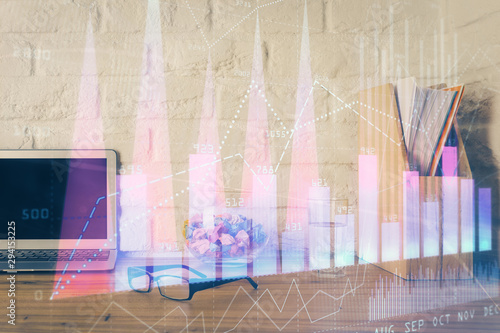 Financial chart drawing and table with computer on background. Multi exposure. Concept of international markets.