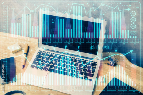 Double exposure of forex graph and work space with computer. Concept of international online trading.