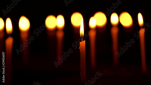 Candles Burning At Temple. Burning candles during Diwali celebration night soft focus video clip. Background footage of hindu, christian, buddhist religious tradition, culture, rituals and ceremony.