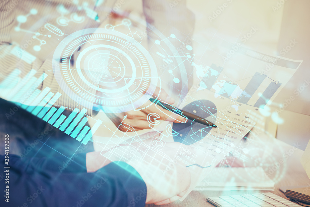 Double exposure of Man writing in notepad with business icons on background. Double exposure of Man writing in notepad with business icons on background.