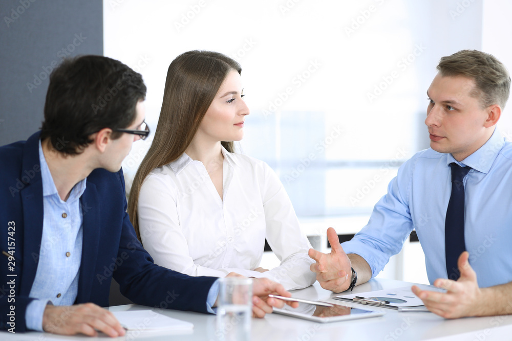 Group of business people discussing questions at meeting in modern office. Managers at negotiation or brainstorm. Teamwork, partnership and business concept Group of business people discussing questions at meeting in modern office. Managers at negotiation or brainstorm. Teamwork, partnership and business concept