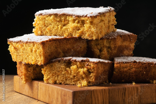 Pieces of cake are stacked on a blackboard. photo