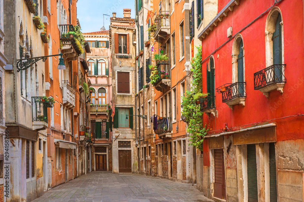 View of the old street in Venice with colorful Venetian houses in Venice, Italy