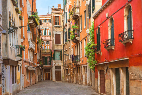 Fototapeta Naklejka Na Ścianę i Meble -  View of the old street in Venice with colorful Venetian houses in Venice, Italy