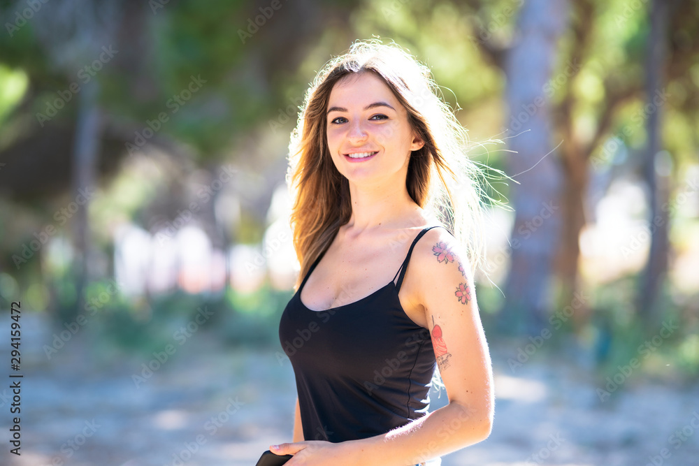 Portrait of young woman at outdoors in a park Portrait of young woman at outdoors in a park