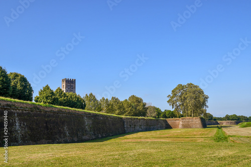 Scenic view of the exterior of the city walls of Lucca (16-17th centuries), longer than 4 kilometers, with the bell tower of the Basilica of Saint Frediano in the background, Tuscany, Italy