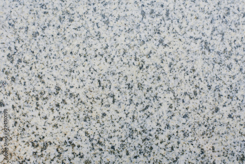 Grey granite background with black grains