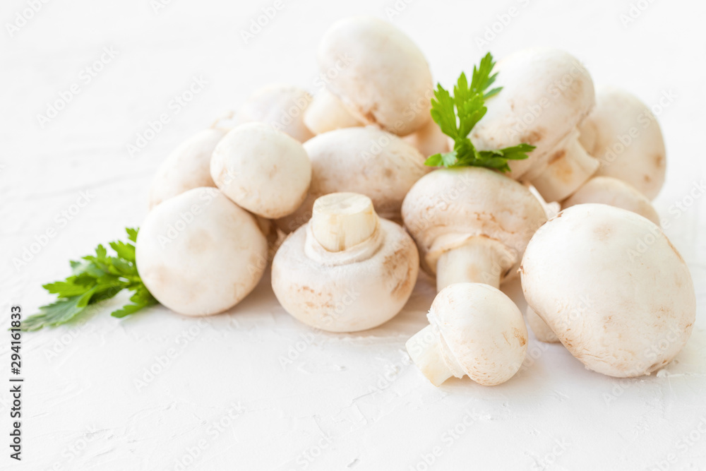 Champignon mushrooms with herbs on white background. Champignon mushrooms with herbs on white background.