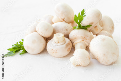 Champignon mushrooms with herbs on white background. 