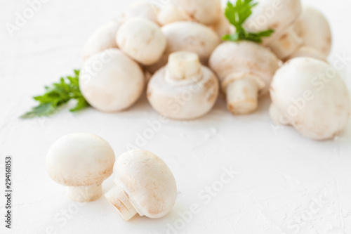 Champignon mushrooms with herbs on white background. 