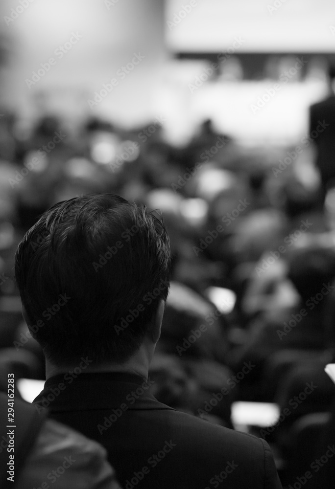 Seminar presenters at business forum giving speech. Speaker giving lecture to conference audience. Defocused managers leading discussion at company training event. Black and white photo. Seminar presenters at business forum giving speech. Speaker giving lecture to conference audience. Defocused managers leading discussion at company training event. Black and white photo.