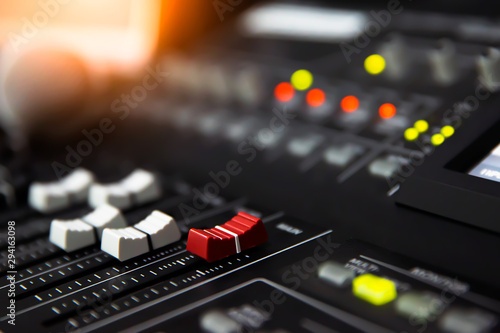 Close-up volume slide of digital sound mixer in the studio for recording, editing, and Sound system control concept.