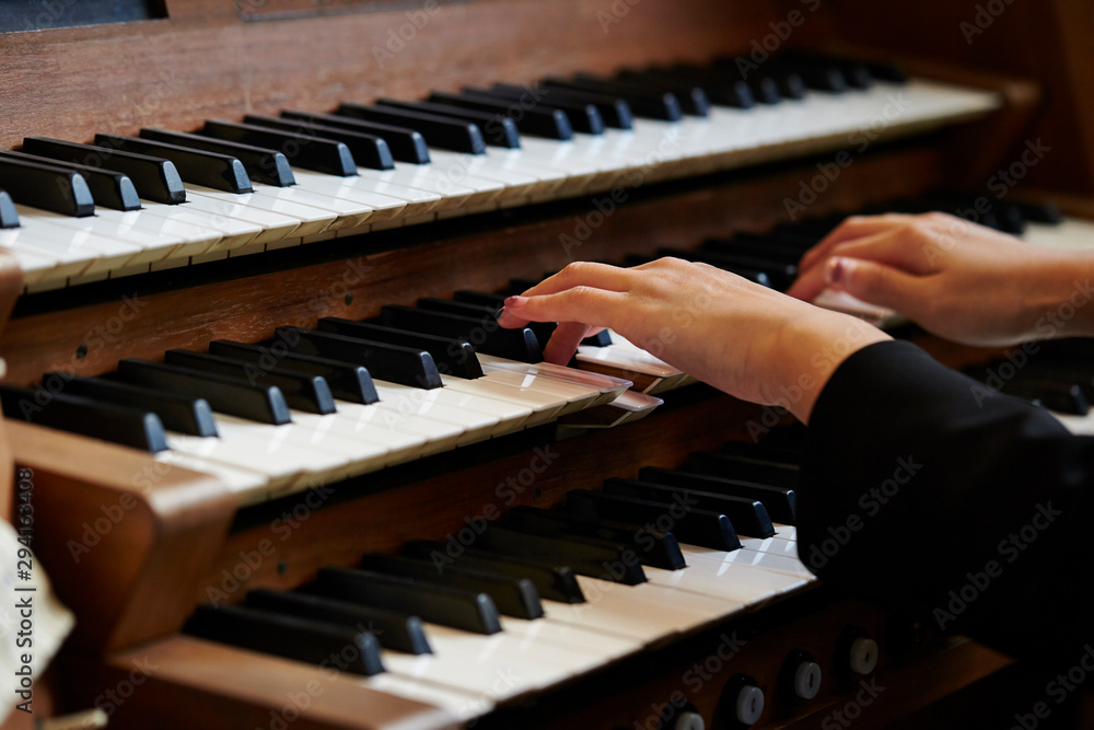 A woman playing the pipe organ 
