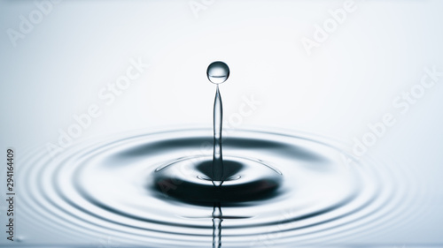 Close-up of a water drop falling on water surface