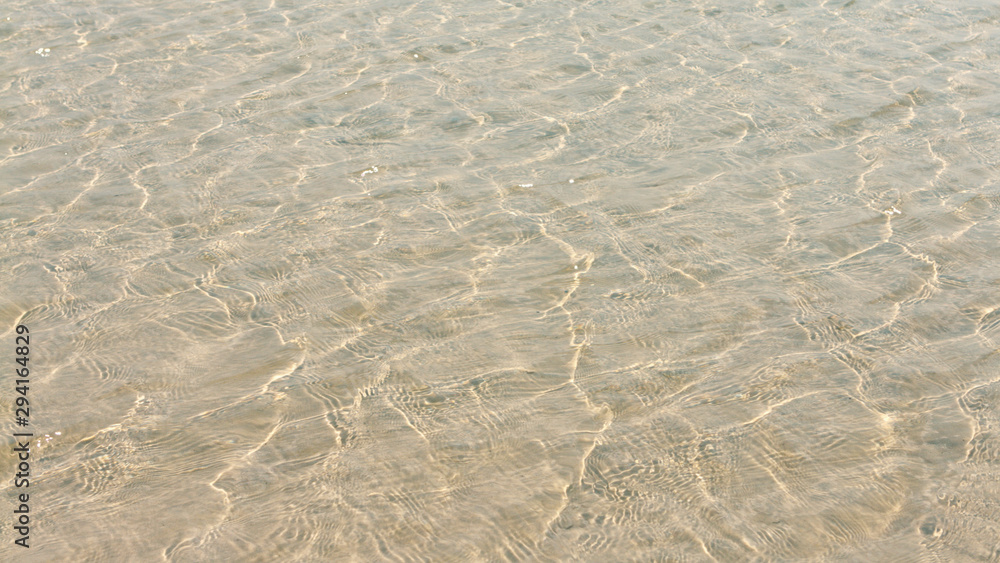 Transparent water ripple, sand waves and sunlight glare. sea floor pattern Transparent water ripple, sand waves and sunlight glare. sea floor pattern