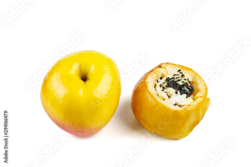 Fresh and stuffed baked apple with sezame seeds and walnuts isolated on a white background photo