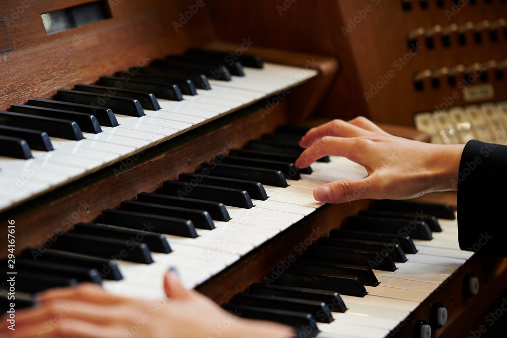 Fototapeta premium A woman playing the pipe organ 