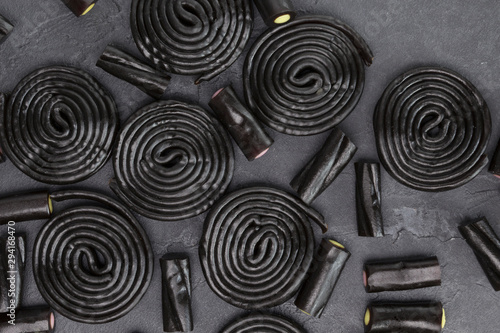 Liquorice sweets on dark concrete background. Recipe, Halloween, dessert concept. Top view, flat lay, copy space photo