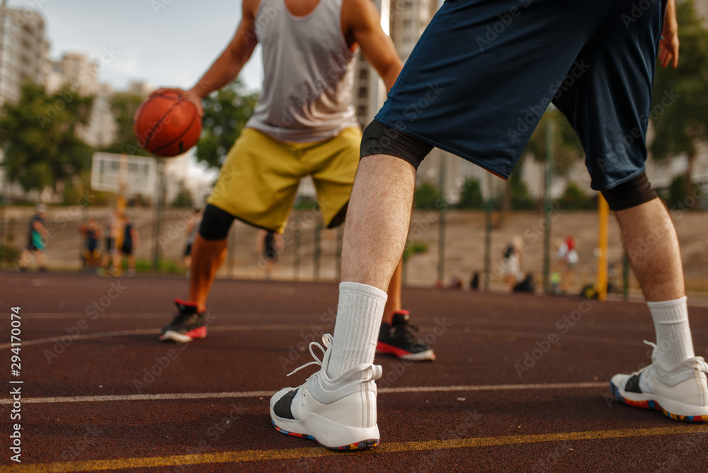 Two players in the center of basketball field