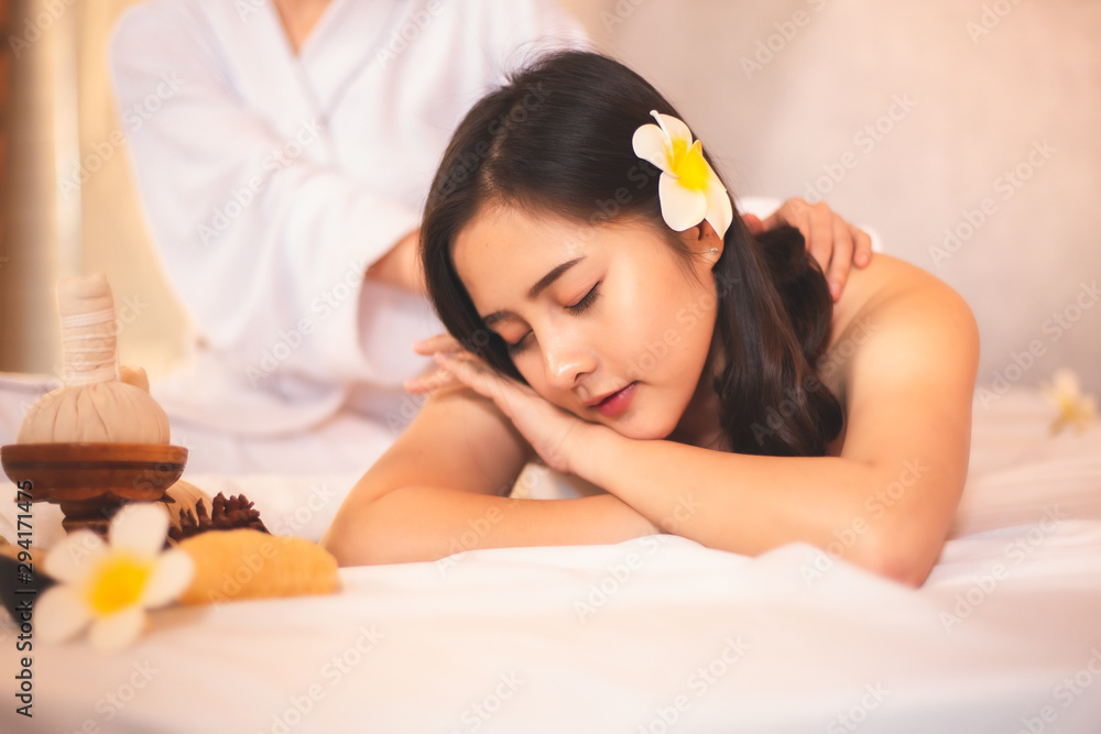 Naklejka premium Asian Beautiful, young and healthy woman in spa salon. Massage treatment spa room . Traditional medicine and healing concept.