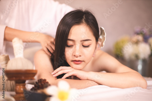 Asian Beautiful  young and healthy woman in spa salon. Massage treatment spa room  . Traditional medicine and healing concept.