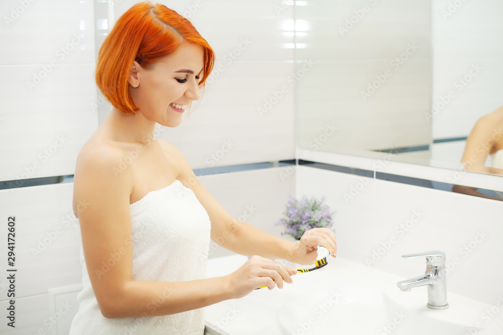 Teeth care. Woman brushes her teeth in a bright bathroom. Teeth care. Woman brushes her teeth in a bright bathroom.