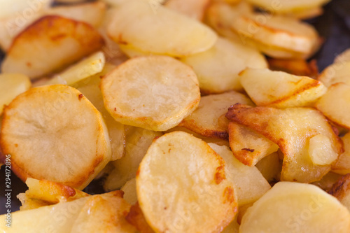 Potatoes fried in a pan on vegetable oil. Potato close-up  cooking.