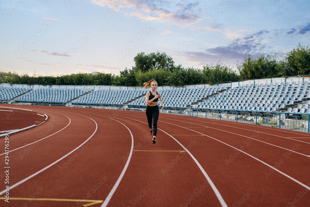 Fototapeta premium Female jogger running, training on stadium