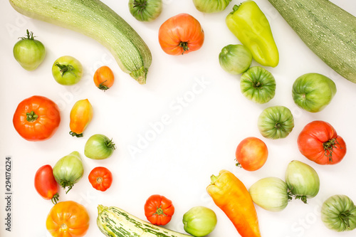 Summer harvest of vegetables concept. Set of green and red peppers, tomato and zucchini.