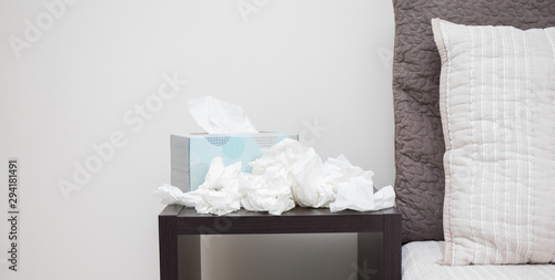 A pile of dirty kleenex on nightstand photo