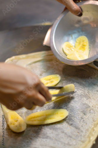 Thai woman cooking and selling traditional Thai sweet pancakes on the street of Khao Lak in Thailand.