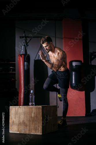 In the dark cross fitness class bodybuilding guy take the running poses then start to run doing his hard workout we ll get sweating