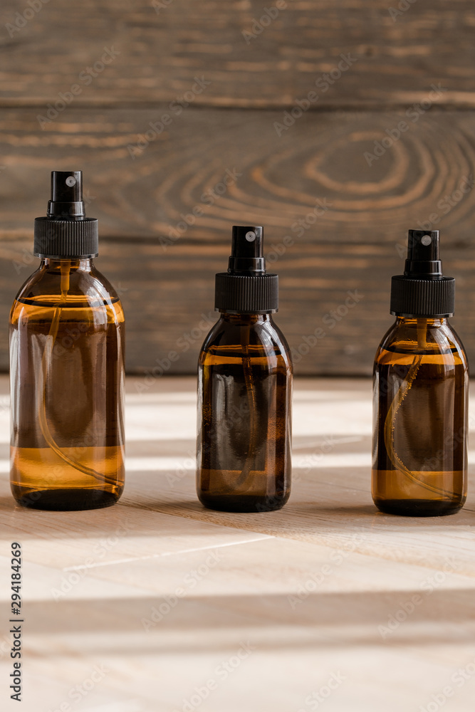 Cosmetic dark amber bottles on wooden  table