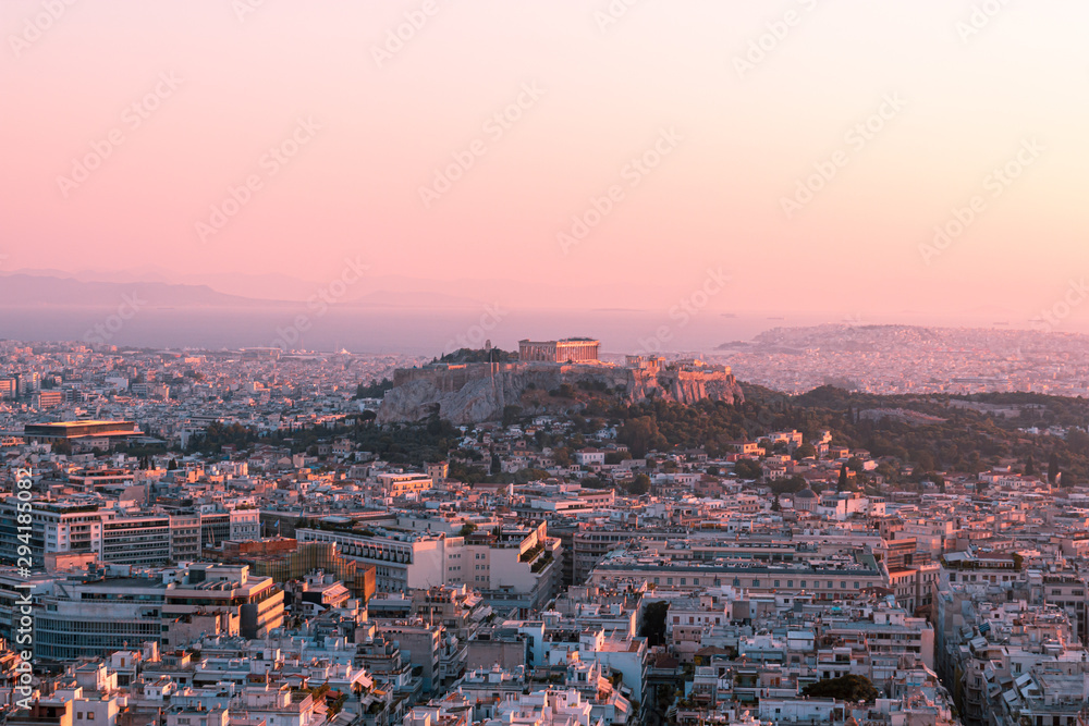 Bright panorama of Athens at sunset, red pink sky and ancient city