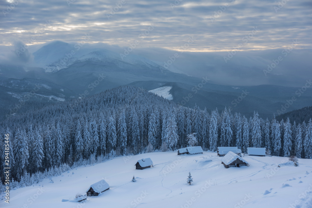 A magical winter in the Ukrainian Carpathian Mountains, on a snowy meadow with beautiful mountain lodges and spruce covered with snow, with beautiful views around A magical winter in the Ukrainian Carpathian Mountains, on a snowy meadow with beautiful mountain lodges and spruce covered with snow, with beautiful views around