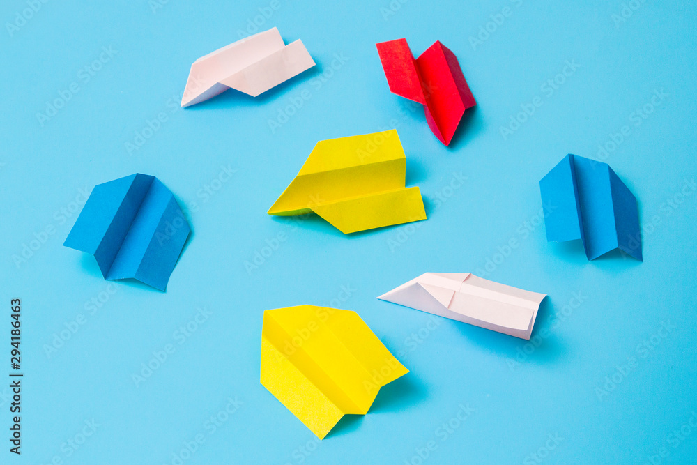 Origami paper airplane on blue background Origami paper airplane on blue background