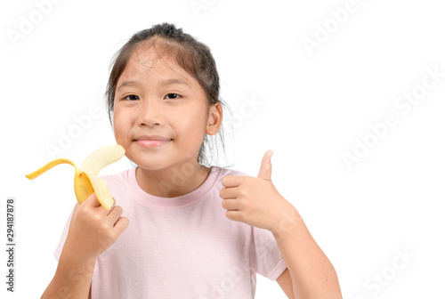 Little asian cute girl eats banana isolated